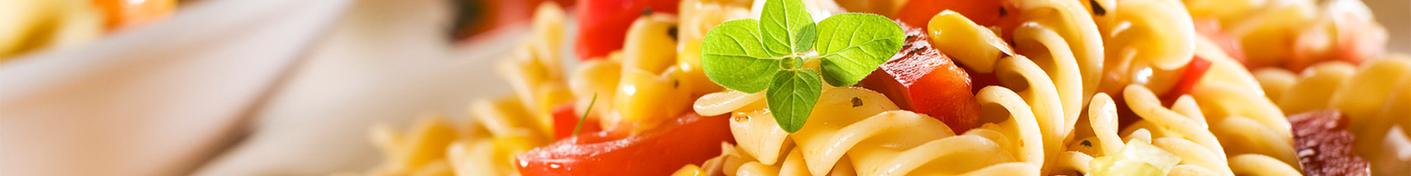 Delicious Macaroni salad with roasted peppers and garnish.